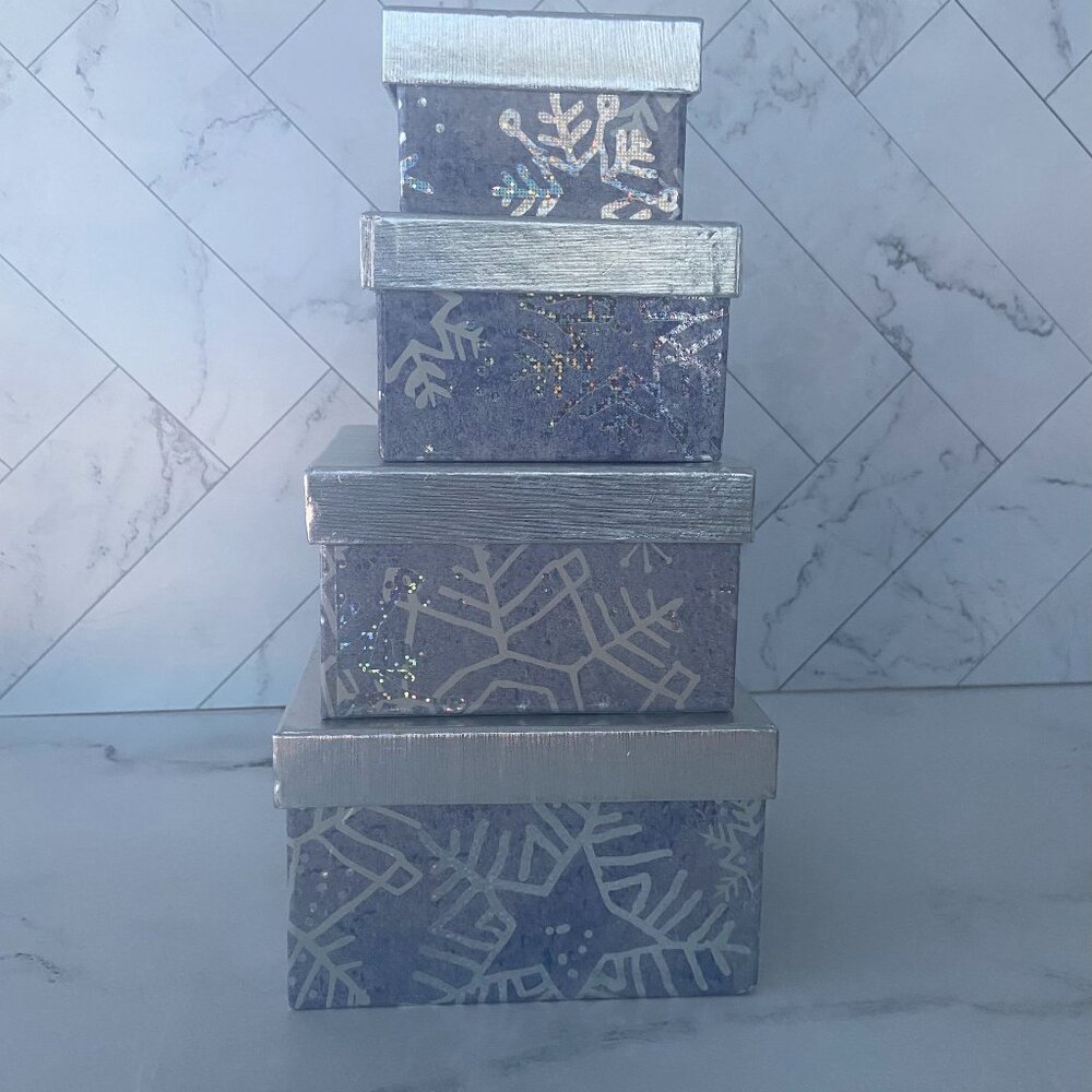 Stack of four silver gift boxes with snowflake design. 4 Holiday Snowflake Boxes